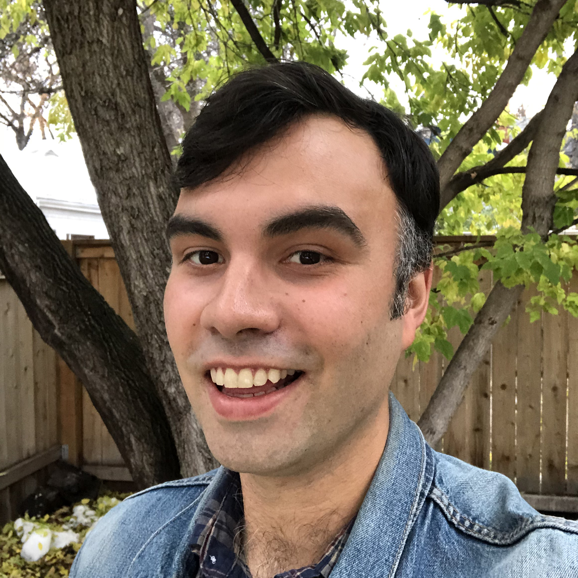 selfie of a man smiling with black hair