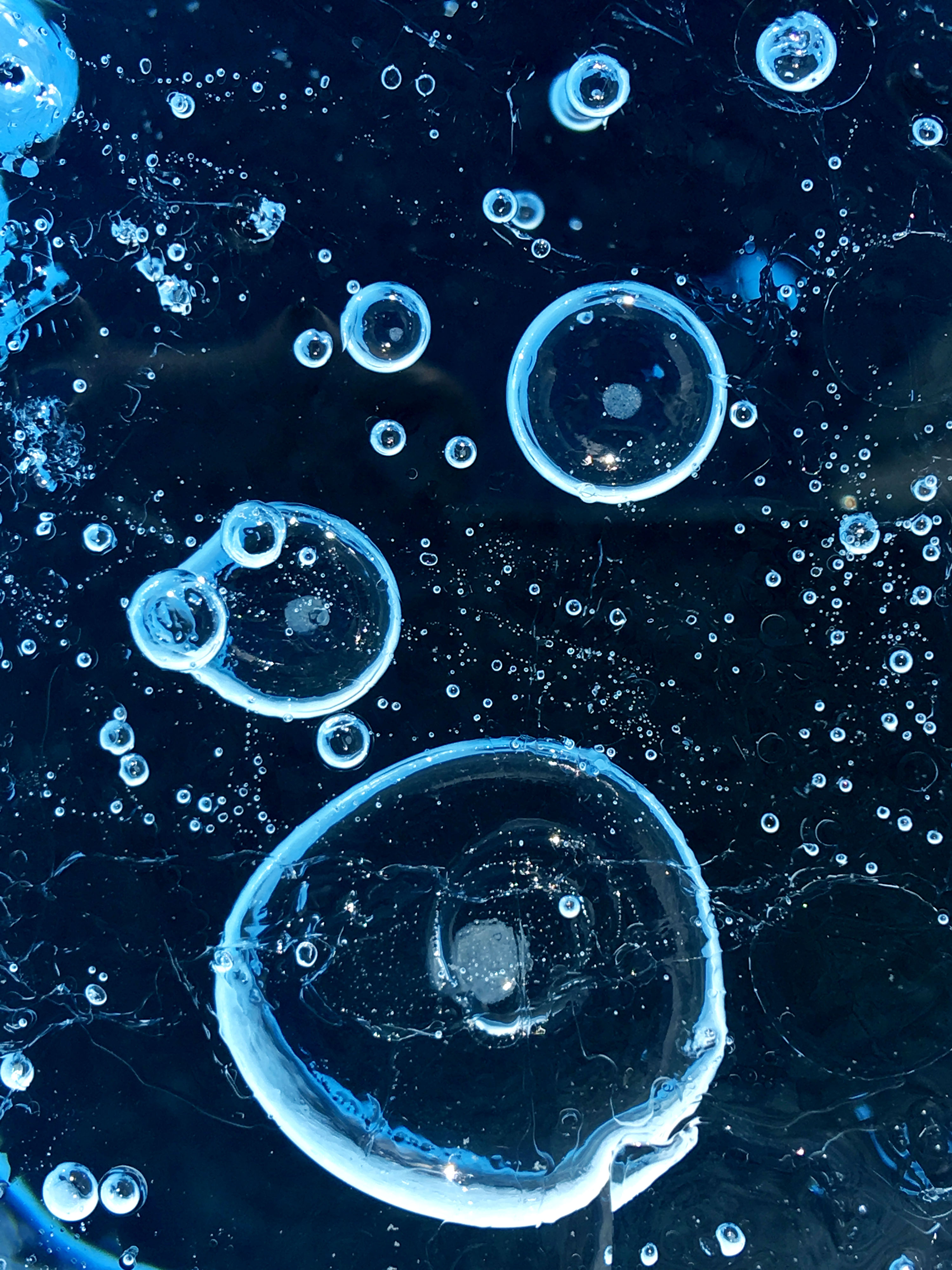 Frozen air bubbles on the top layer of ice on a glacier.